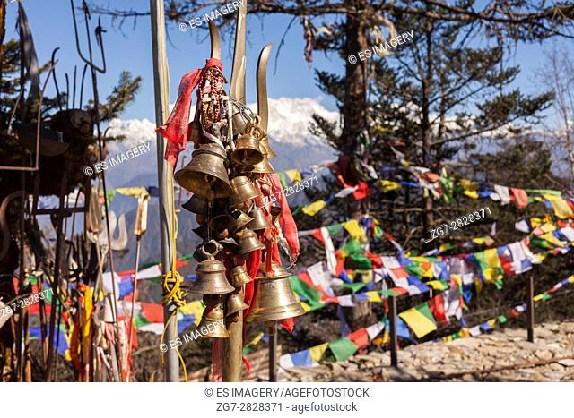 Bells hanging from trishula and prayer flags, Pathivara Devi Temple, Taplejung, Nepal