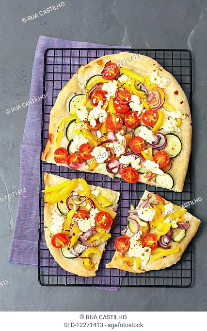 Vegetarian focaccia with pepper, courgette, onion, cherry tomatoes and feta