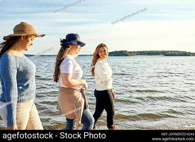 Female friends walking at sea