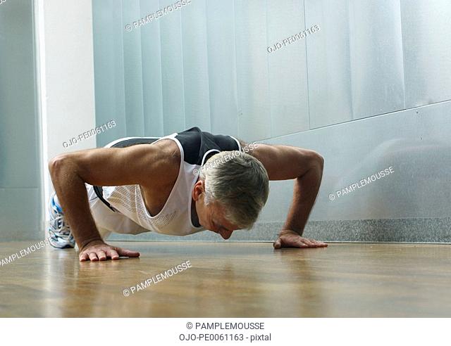 Man in gym doing push-ups