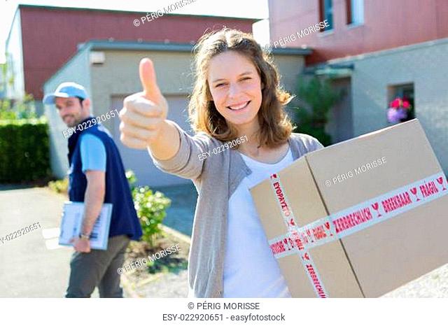 Young attractive woman happy to receive parcel