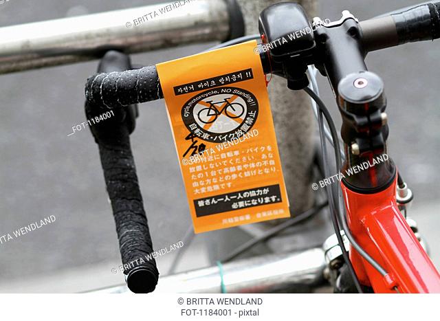 A No Standing parking ticket for bicycle in English and Japanese