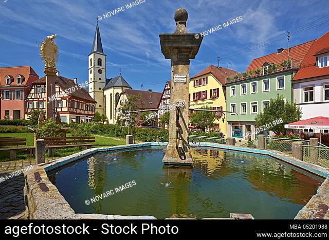 Parish Church of the Assumption and fountain at the market in Aub, Lower Franconia, Bavaria, Germany