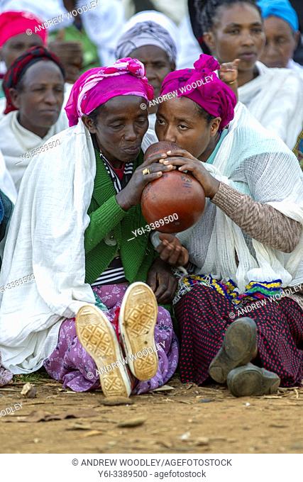 Women drink traditional beer from calabash Chencha market. Southern Ethiopia