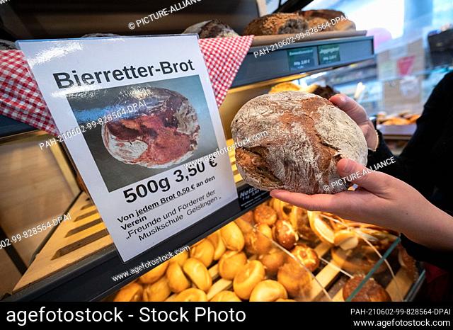 28 May 2021, Baden-Wuerttemberg, Geislingen an der Steige: An employee of the Kiene bakery holds a Bierretter bread in her hands