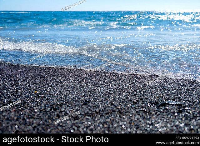 ocean water on black sandy beach. outdoor shot on Tenerife, Spain. Copy space