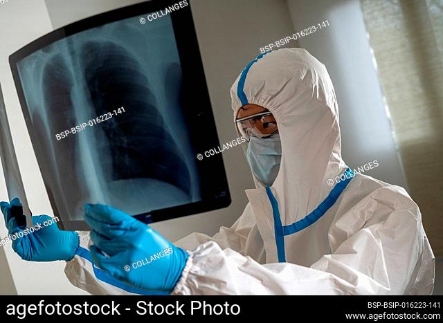 Doctor in a Covid ward of a hospital examining x-rays of the lungs