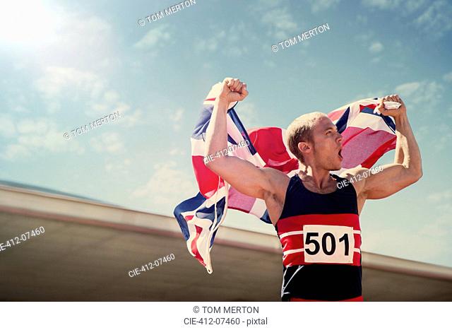 Track and field athlete holding British flag