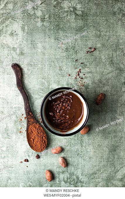 Cup of chocolate pudding with cacao, cacao nibs and cocoa beans