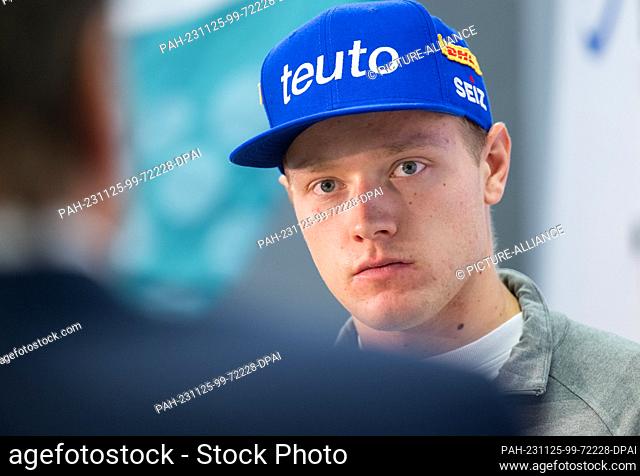 24 November 2023, Saxony, Dresden: Luger Max Langenhan stands on the podium during the press conference of the German Bobsleigh and Luge Federation ahead of the...