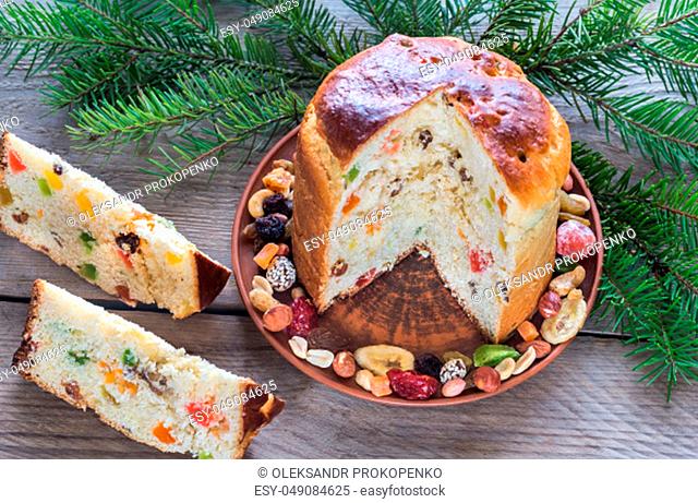 Panettone with dried fruits on the wooden background