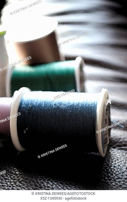 Several rolls of different colored thread with effects