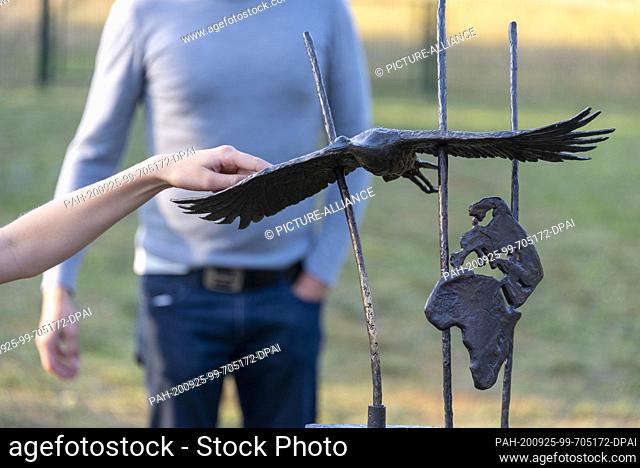 20 September 2020, Saxony-Anhalt, Loburg: A visitor touches the stork ""Princess"" on the grounds of the ornithological station