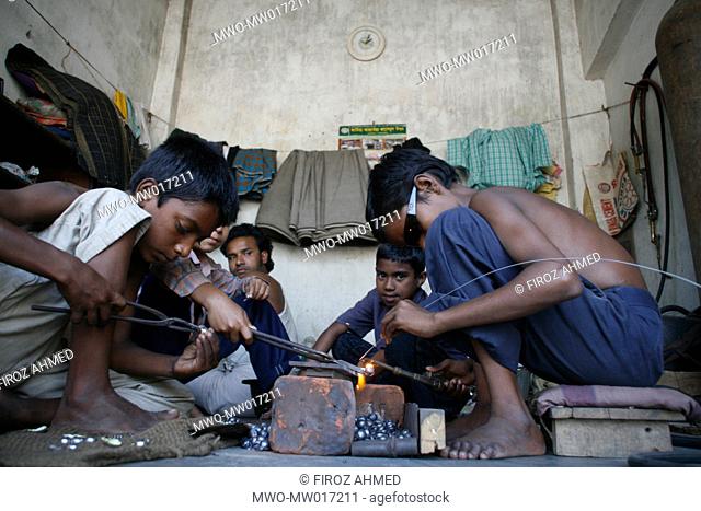 Children work at a welding shop, in Shampur, Dhaka, Bangladesh march 25, 2008