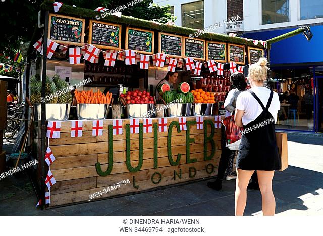 A fruit drink stall near Bond Street underground station decorated with St George's flag. England next plays Colombia in the knock out stages on Tuesday 3 July