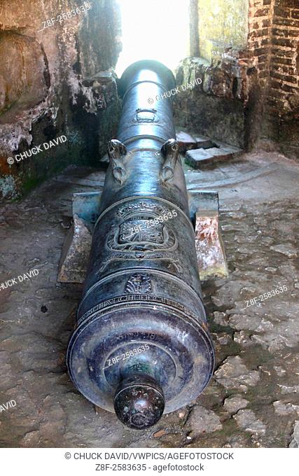 Long cannon with a royal crest on it aimed through a Citadel window, Milot, Cap Haitien, Haiti