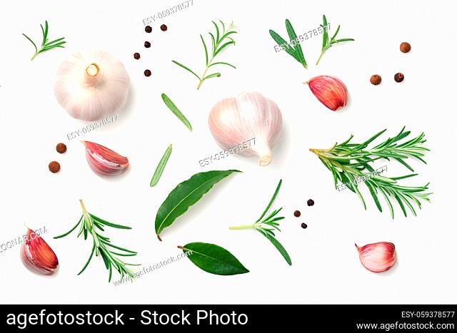 Garlic, rosemary, bay leaves, allspice and pepper isolated on white background. Flat lay. Top view