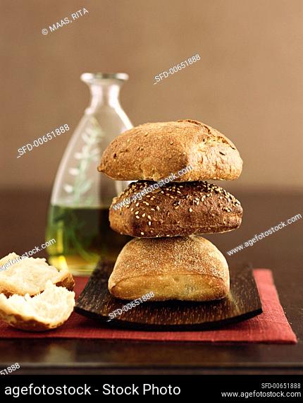 Three Loaves of Bread, Stacked, with a Bottle of Olive Oil