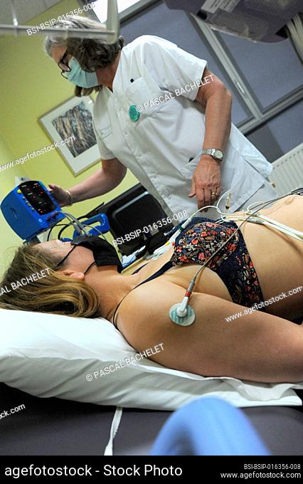 A 40-year-old woman undergoes an EKG machine to assess her heart function