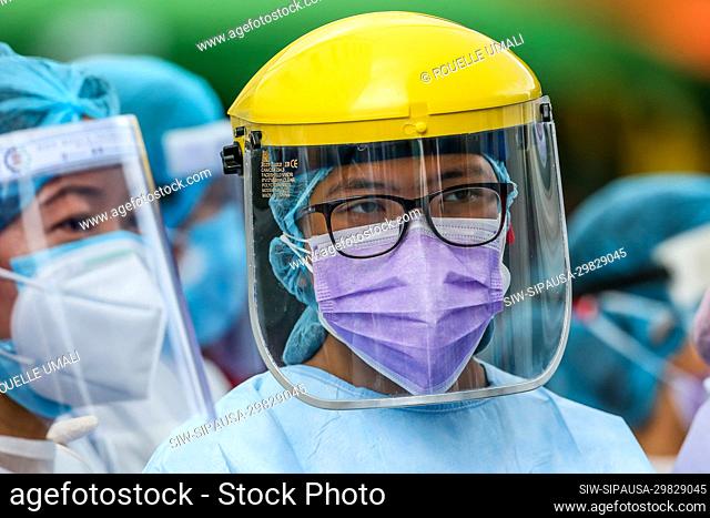 (200511) -- MANILA, May 11, 2020 (Xinhua) -- Nurses wearing protective equipment are seen at a triage area as they wait for patients outside a hospital in...