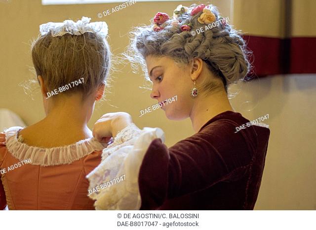 Woman arranging a lady's dress, court life in the Stupinigi hunting lodge, Italy, 18th century. Historical re-enactment