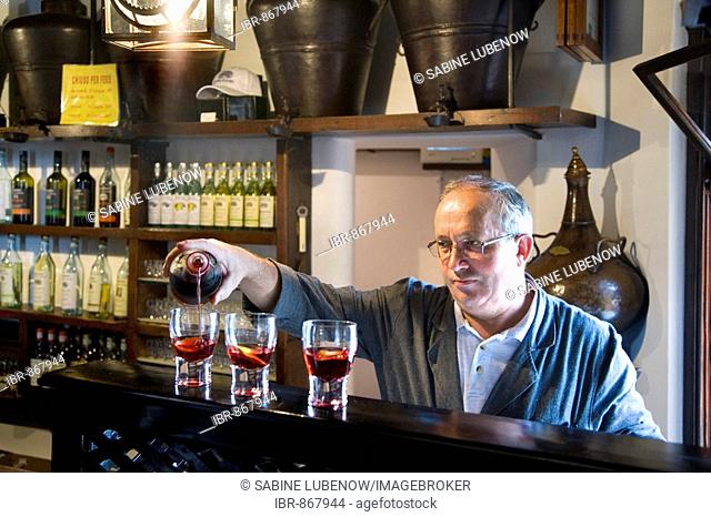 Waiter filling grappa into glasses, Nardini-grappa pub, Bassano del Grappa, Veneto, Italy, Europe
