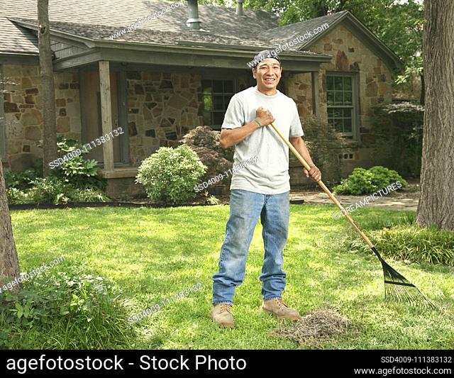Native American man raking front yard