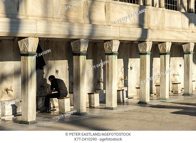 Man Washing before entering for prayer at the Sultan Ahmet or Blue Mosque, Sultanahmet, Istanbul, Turkey