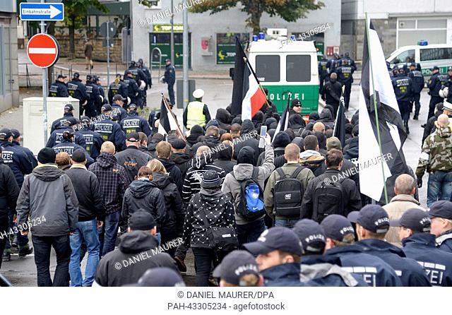 Protected by police forces far-right extremists march through the city center of Göppingen, Germany, 12 October 2013. According to police statements about 100...
