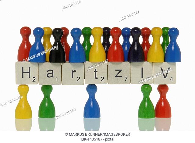 Few game pieces carrying more game pieces on scrabble pieces with the lettering Hartz IV, symbolic for demographic, Hartz IV