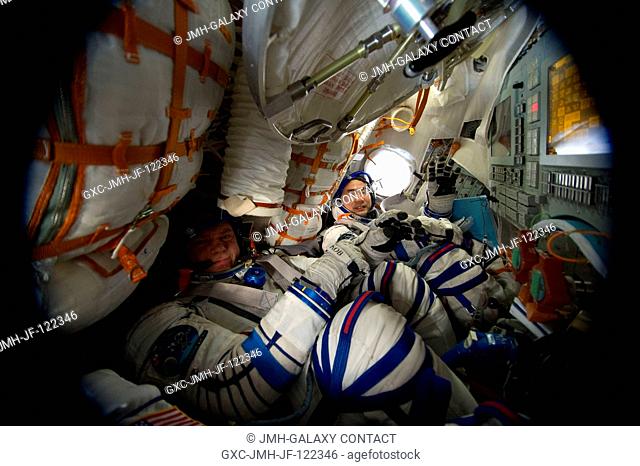 Attired in their Russian Sokol launch and entry suits, Russian cosmonaut Oleg Kotov (left), Expedition 23 commander; along with Japan Aerospace Exploration...