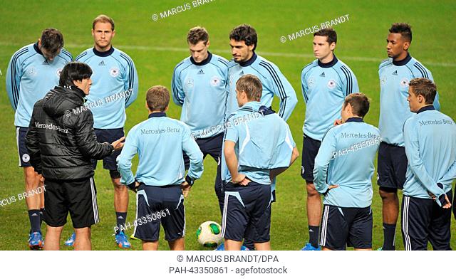 German national soccer coach Joachim Loew speaks to his players during the final training before the match against Sweden at Friends Arena Solna in Stockholm