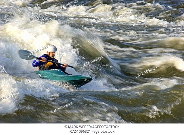 Man kayaking The Wave a rapid rated Class 4 on The Snake River near the town of Hagerman in southern Idaho USA