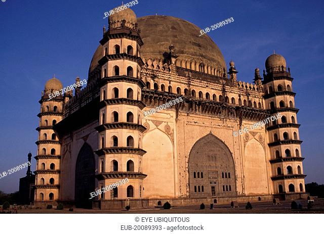 The Golgumbaz. Exterior of domed building with octagonal seven-storey towers at each corner. Built in 1659 as the mausoleum of Mohammed Adil Shah