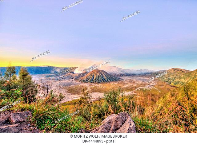 Sunrise, smoking volcano Mount Bromo, Mt. Batok at front, Mt. Kursi at back, Mt. Gunung Semeru, Bromo Tengger Semeru National Park, Java, Indonesia