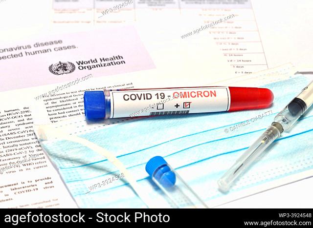 Blood tube for test detection of virus Covid-19 Omicron Variant with positive result on protection mask and document. Concept of protection from new variant of...