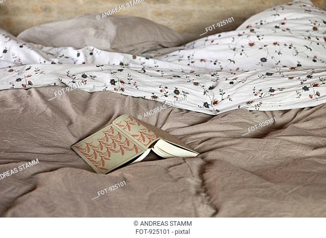 An open book on a bed