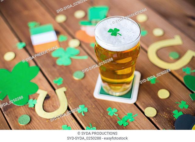 glass of beer and st patricks day decorations