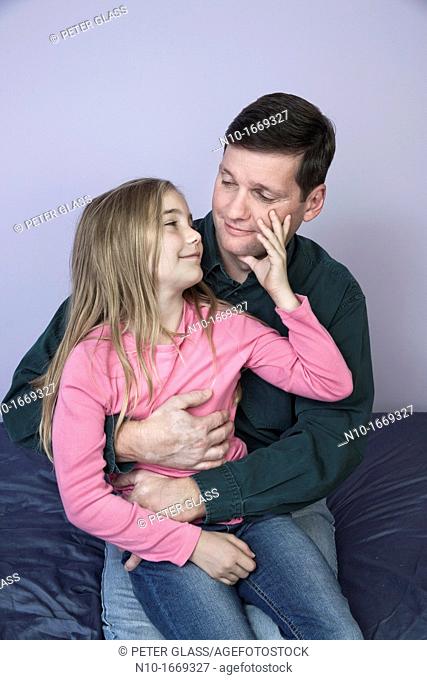 Young blonde girl with her father