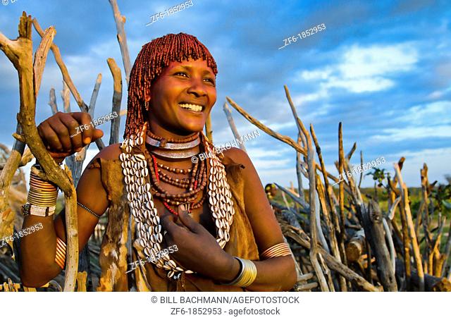 Turmi Ethiopia Africa Lower Omo Valley village with Bena Tribe First Wife smiling in sunset in wood hut village 24
