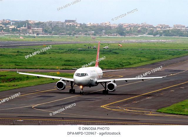 Aeroplane ; Indian Airlines flight taking off from runaway of Chhatrapati Shivaji International Airport terminal;  Bombay; Mumbai; Maharashtra; India