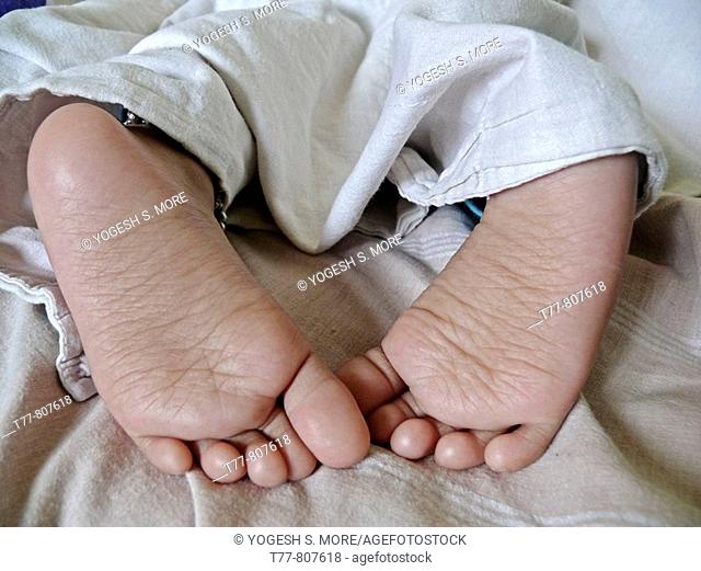 Close-up of a child's feet sleeping in a bed  Pune, Maharashtra, India