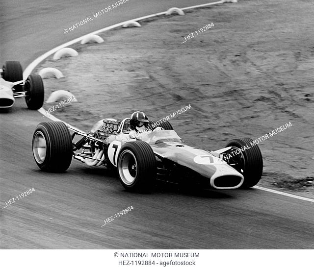 Graham Hill in a Lotus 49, French Grand Prix, Le Mans, 1967. Hill, driving a Lotus 49-DFV, leads teammate Jim Clark through one of the tyre-lined corners of the...