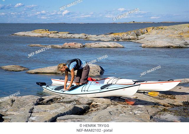 Woman preparing to go kayaking