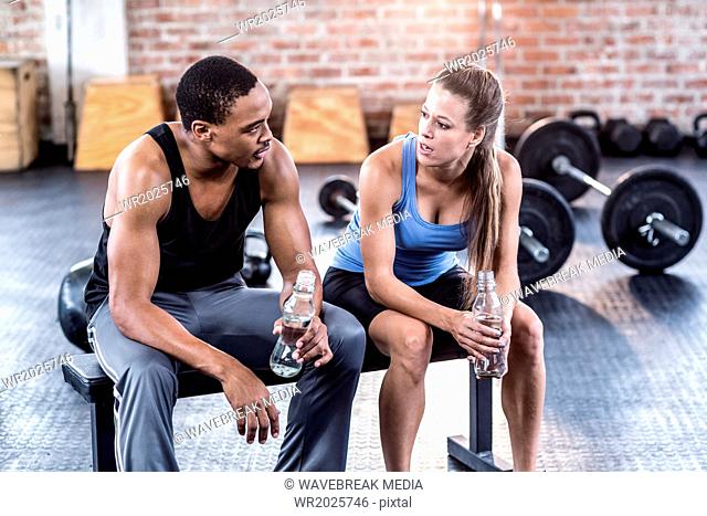 Fit couple drinking water together
