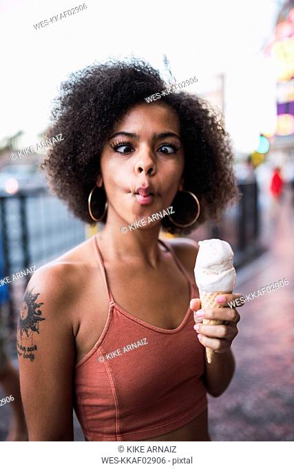 USA, Nevada, Las Vegas, portrait of young woman holding ice cream cone grimacing