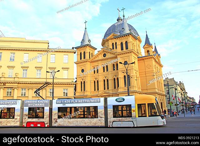 Modern tram going on street of Lodz. Popular touristic attraction and destination. Colored tramway going along city. Modern passenger transportation