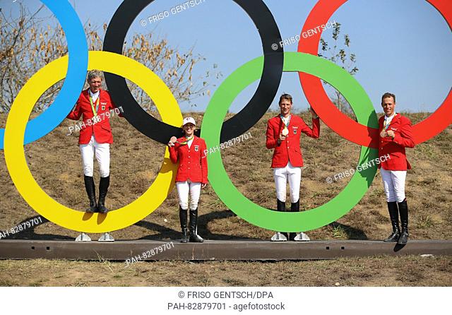Bronze medalists (L-R), Ludger Beerbaum, Meredith Michaels-Beerbaum, Daniel Deusser and Christian Ahlmann of Germany pose in Olympic rings after the medal...