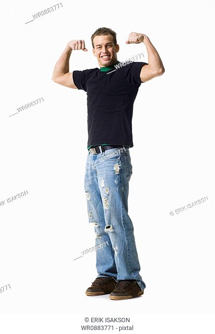 Portrait of a young man flexing muscles