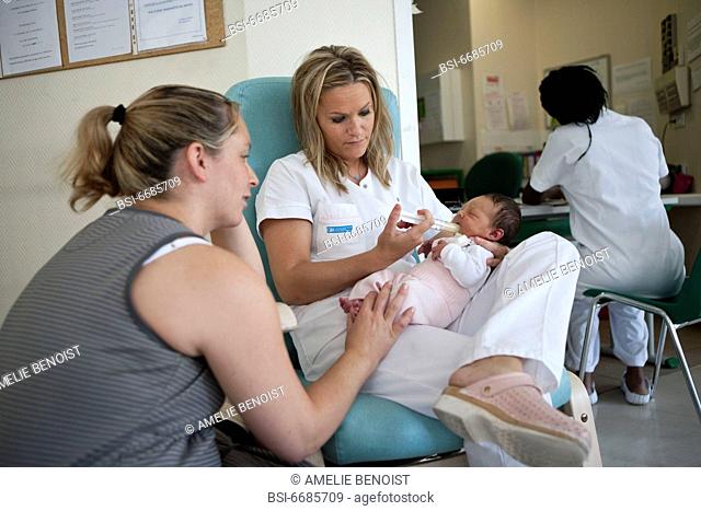 Photo essay at the maternity of the Diaconesses hospital in the 12th district of Paris, France. The child care aid giving a supplement maternized milk to a...